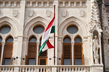 National flag of Hungary installed on a balcony of the Hungarian Parliament Building (Hungarian:...