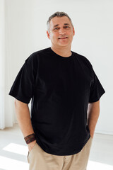 A 50-year-old man in a black t-shirt