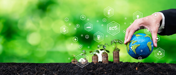 Stack of money growing with businessman investing in eco-friendly technology, green business investment and economic financial sustainable growth on environmental sustainability. Panorama Reliance