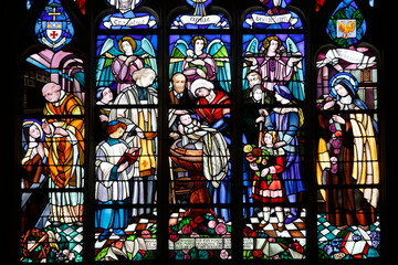Notre Dame basilica, Alencon, Orne. Stained glass depicting St. Therese's baptism, located in the chapel where Therese was baptised.