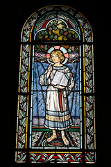 Fototapeta premium Saint Honore d'Eylau church, Paris, France. Stained glass. Jesus as a child holding the Gospel.