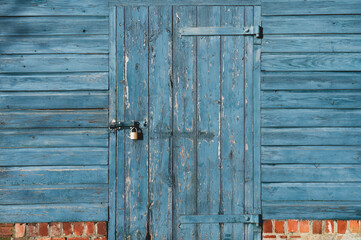 Wood Background Grain Texture Wall with Metal Hinges,Old Wood Door Rustic Gate with Locked,Garage Door with Padlock,Barn entrance with blue peeling paint,Exterior Vintage Building