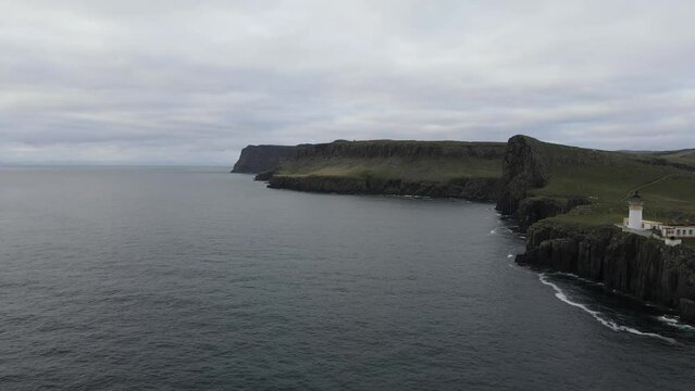 Aerial walkthrough of Neist Point, revealing a glimpse of its rugged cliffs, iconic lighthouse, and the untamed beauty of the Scottish coastal landscape. Captivating and peaceful scenery