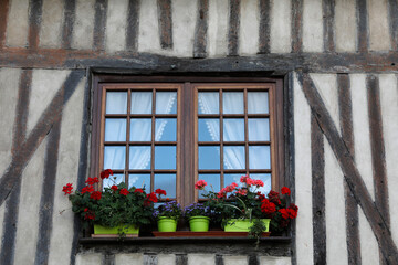 Fototapeta na wymiar Flowered balcony in Bernay, Eure, France.