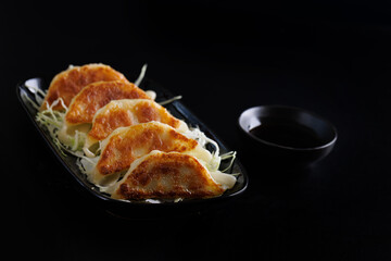 Gyoza Japanese food dumpling isolated in black background