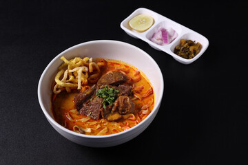 Khao Soi Thai Curry soup isolated in black background