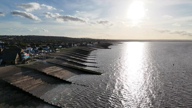 Whitstable beach  groins  Kent UK  Drone, Aerial, into setting sun 4K