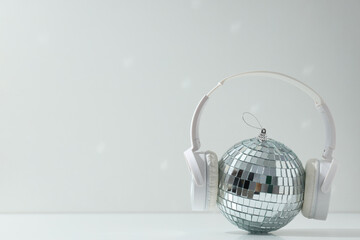 A beautiful disco ball with headphones on a light background