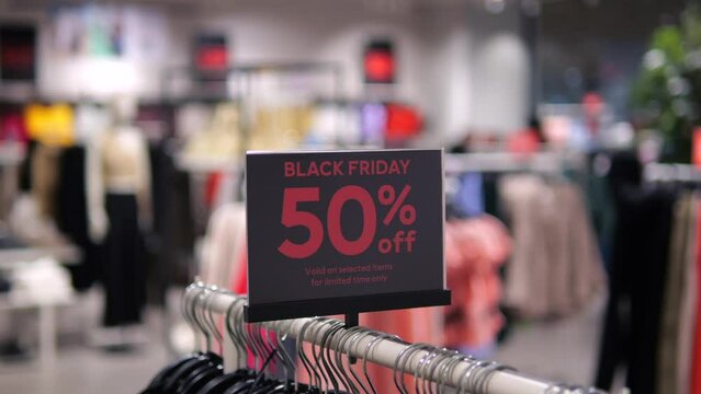 Closeup of sign with Black Friday sale and holiday season 50 percent off. Bright sign with announcement for sales and promotion of discounts store. Offer that is highlighted to draw attention to sale.