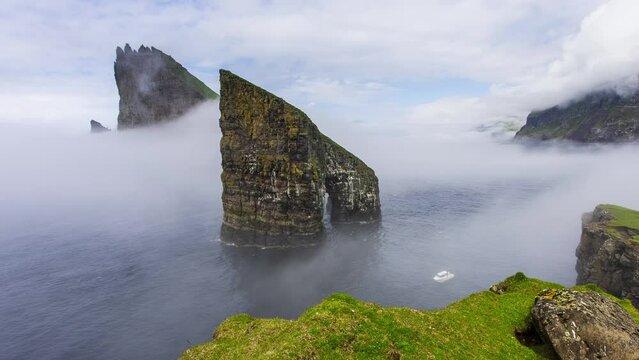 Time lapse of Drangarnir Rocks during mist and fog in the Faroe Islands, Denmark