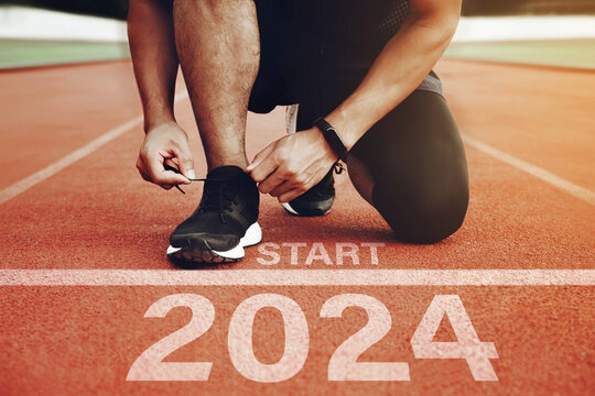 Athletes Are Getting Ready To Run On The Track With The Text  2024 In New Year's Start Concept. Start The New Year 2024 And Reach New Goals And Achievements. Planning, Challenges, New Year Resolution.