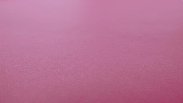 Women's intimate sanitary pads fall on a pink background. The concept of protection against leakage in women on critical days. Copy space for text. Slow motion