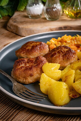 Meatballs  served with fired potatoes.