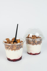 Complete meal contained in this cup of yogurt, blueberries, strawberries, and granola for plenty of protein and carbohydrates to eat.