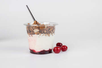 Complete meal contained in this cup of yogurt, blueberries, strawberries, and granola for plenty of protein and carbohydrates to eat.