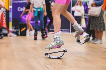 Kangoo shoes, fitness jumping training, group of young fit women in sportswear on kangoo jumps,...
