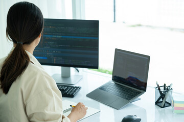 Female IT programmer innovates at office desk.
