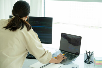 Obraz na płótnie Canvas Female IT programmer innovates at office desk.