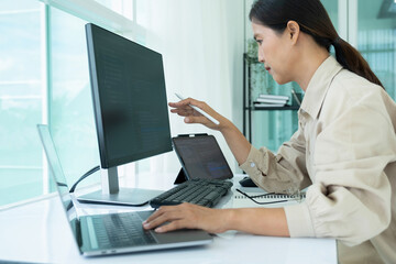 Female IT programmer innovates at office desk.