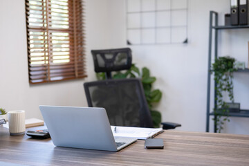 Woman casually working at home office.