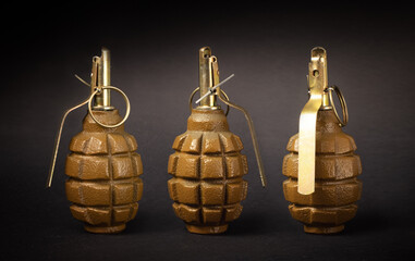 Several hand grenades on a dark background
