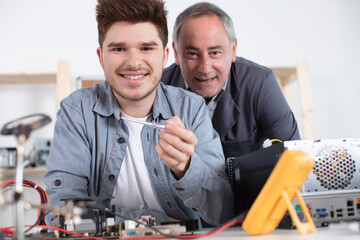 portrait of a an apprentice technician with his mentor