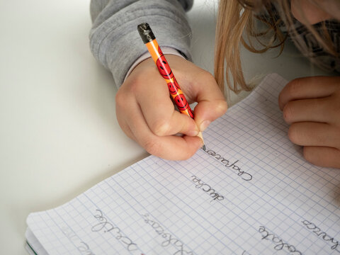 Ni&ntilde;a escribiendo palabras con l&aacute;piz 