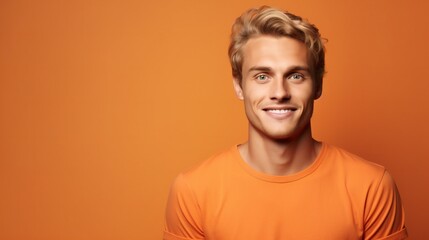 Fototapeta na wymiar Young cheerfull blond european man he wearing basic orange t-shirt. Looking camera isolated on plain orange color background studio