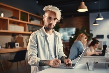 Graphic designer working with tablet in modern office.