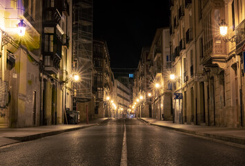 Fototapeta na wymiar Central old town street at night in Logrono, north Spain. Small city urban lights in summer in an old street in the middle of the city