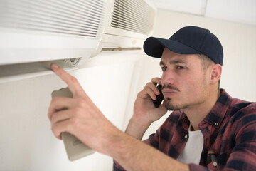 young repairman contractor on the phone