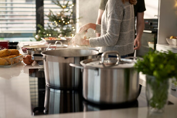 Selective focus of caucasian couple preparing food before Christmas