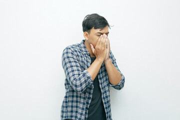 Portrait of Indonesian Asian man sneezing gesture. Unhealthy sick concept isolated white background