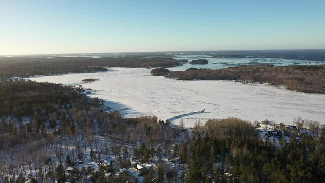 Aerial view of winter coast landscape. Frozen sea and snow covered gorund