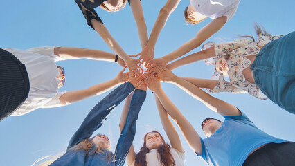 Fototapeta premium Friends putting their hands together in a sign of unity and teamwork. Just the hands.