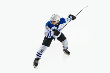 Obraz premium Man, ice hockey player in motion during game with stick, training, playing against white studio background