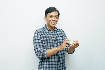 Portrait Asian Indonesian young man spraying perfume to his body