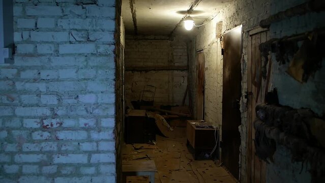 war in Ukraine
a bomb shelter in a civilian residential building
the gloomy atmosphere of people's lives during rocket attacks
a dingy basement hallway with minimal lighting and seating