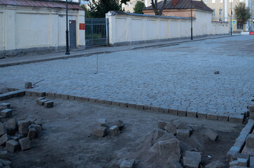 Laying paving slabs on a sidewalk being repaired