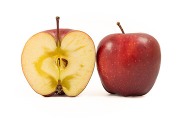 A whole red apple and a half on a white background