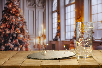 Wooden table and christmas small lights decoration. Free space for your decoration. Blurred...