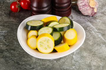 Sliced raw young green and yellow zucchini