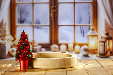 Wooden retro yellow table and blurred background of window sill. Christmas tree and empty space for your decoration. Natural light and magic time. Mockup background and cold december time.