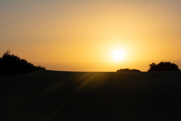 Fototapeta na wymiar Sand dunes at sunrise