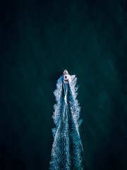 Aerial view of speed motor boat on open blue sea