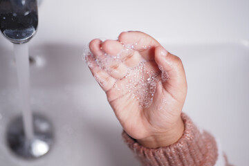 Fototapeta premium child washing hands with soap 