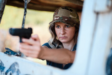 A girl with a pistol in her hand undergoes military training and learns to shoot.