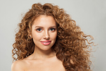 Redhead woman fashion model with long wavy hairstyle, natural makeup and clear skin. Haircare,...