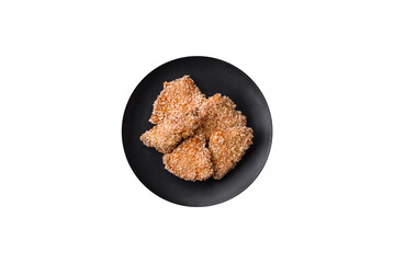 Delicious fresh crispy chicken nuggets on a dark concrete background