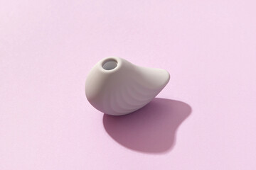 Purple clitoral vibrator on the purple background. Sex toys for adults. Flat lay, top view